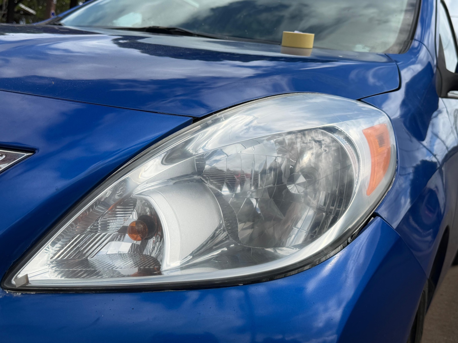 Clear blue Nissan headlight after restoration, angle two